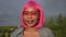 Young attractive happy black woman with pink hair closeup outdoors