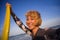 Young attractive and happy blonde surfer woman in swimsuit holding surf board in the beach taking self portrait selfie picture smi