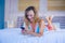 Young attractive and happy girl smiling cheerful and relaxed using internet social media app on mobile phone on bed feeling relaxe