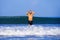 Young attractive and happy man with beard and swimming trunks at tropical paradise desert beach alone playful and cheerful in sea