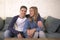 Young attractive happy and romantic couple boyfriend and girlfriend cuddle tender at home couch smiling playful in beautiful teena