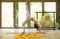 Young attractive and healthy Asian Indonesian acrobat woman practicing acro yoga exercise in balance pose at traditional studio