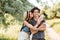 Young attractive hipster couple kissing at the forest background