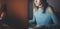 Young attractive hipster girl working on modern loft office at night. Woman using contemporary desktop computer, blurred