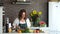 Young attractive housewife prepares a romantic dinner in the kitchen. Bright modern kitchen interior, mother`s day
