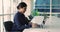 Young attractive Indian woman working on laptop posing on camera