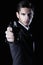 Young attractive macho in suit with gun