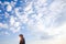 Young attractive man in blue sky view background feeling wind and sunshine. Hipster male in youth freedom culture travel concept