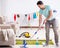 Young attractive man husband doing mopping at home