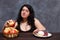 Young attractive overweight woman choosing healthy foods and giv