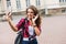 Young attractive playful tourist is making selfie on the phone o