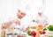 Young attractive professional chef cooking in his kitchen