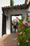 Young attractive smiling couple walking through open doorway in Betancuria, Fuerteventura