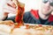 Young attractive smiling man eating pizza at street cafe. Cheat meal. Cheat day.