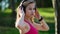 Young attractive sportswoman listening to music wearing headphones.