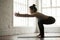 Young attractive sporty woman doing exercises, white loft studio