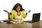 Young attractive stressed and overworked black African American woman working upset and desperate at office computer desk feeling