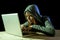 Young attractive teen woman wearing hood on hacking laptop computer cybercrime cyber crime concept