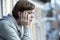 Young attractive unhappy depressed lonely woman staring hopeless and worried on the balcony at home