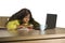 Young attractive unhappy and exhausted black afro American woman working lazy on Monday at office computer desk feeling overwhelme