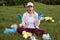 Young attractive volunteer sitting in middle if meadow and screaming in despair, worries of planet ecology, fights with pollution