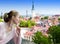 Young attractive woman admires roofs of houses of the Old city from an observation deck. Tallinn. Estonia.