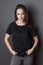 Young attractive woman in black t-shirt  studio shot,  mock up