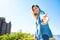 Young attractive woman on the blue sky background