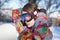 Young attractive woman in bright sportswear puts on special glasses for snowboarding and winter sport.