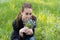 Young attractive woman brought a bouquet of forget-me-nots to her face