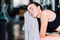 Young attractive woman caucasian sitting and using towel to wipe the sweat. Relaxation after hard workout in gym.