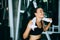 Young attractive woman caucasian sitting and using towel to wipe the sweat. Relaxation after hard workout in gym.