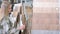 A young attractive woman is choosing a floor covering in a large hardware store