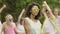 Young attractive woman dancing with group of friends at music festival, partying