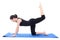 Young attractive woman doing fitness exercise on blue yoga mat i