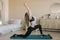 Young attractive woman doing yoga in her living room.Natural light ambient.