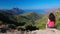 Young attractive woman enjoying the view from famous D81 coastal road with view of Golfe de Girolata from Bocca Di Palmarella