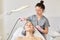 Young attractive woman getting ultrasonic facial skin cleansing treatment by professional cosmetologist, in beauty salon.