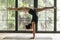 Young attractive woman in Handstand pose, home background