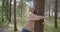 Young attractive woman hugs a tree in a summer forest park