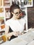 Young attractive woman in monochrome dress reading book in a book store