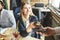 Young attractive woman paying in cafe with contactless smartphone payment