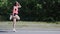 Young attractive woman performing funny dance. Cute caucasian girl fooling around in park. Pretty girl laughing and dancing. Woman