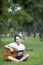 Young attractive woman playing acoustic guitar