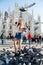 Young attractive woman posing with pigeon near Milan Cathedral, Italy