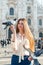 Young attractive woman posing with pigeon near Milan Cathedral, Italy