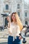 Young attractive woman posing with pigeon near Milan Cathedral, Italy