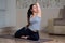 Young attractive woman practicing yoga, wearing sportswear, meditation session, home interior