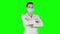 Young attractive woman putting on health mask. Green screen