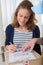 Young attractive woman signing delivery note